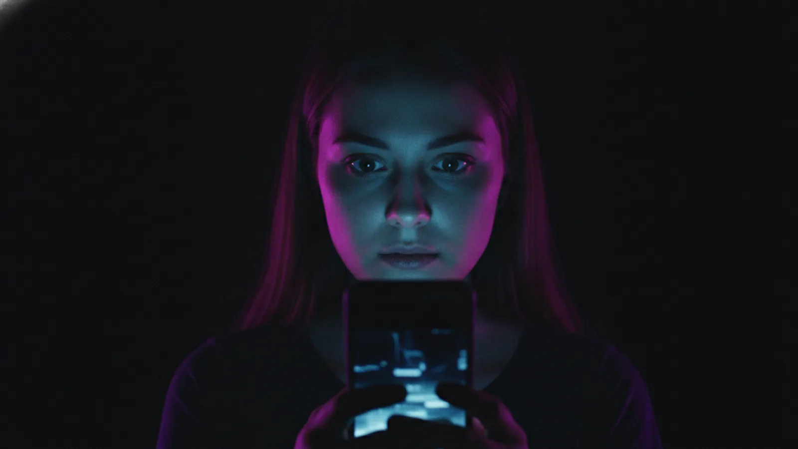 A viewer watching a vertical short drama on a phone in a dark room